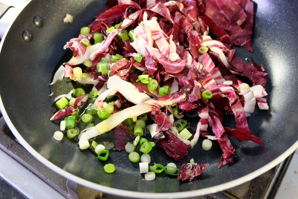 Spring onion and radicchio ready to sautee in a pan